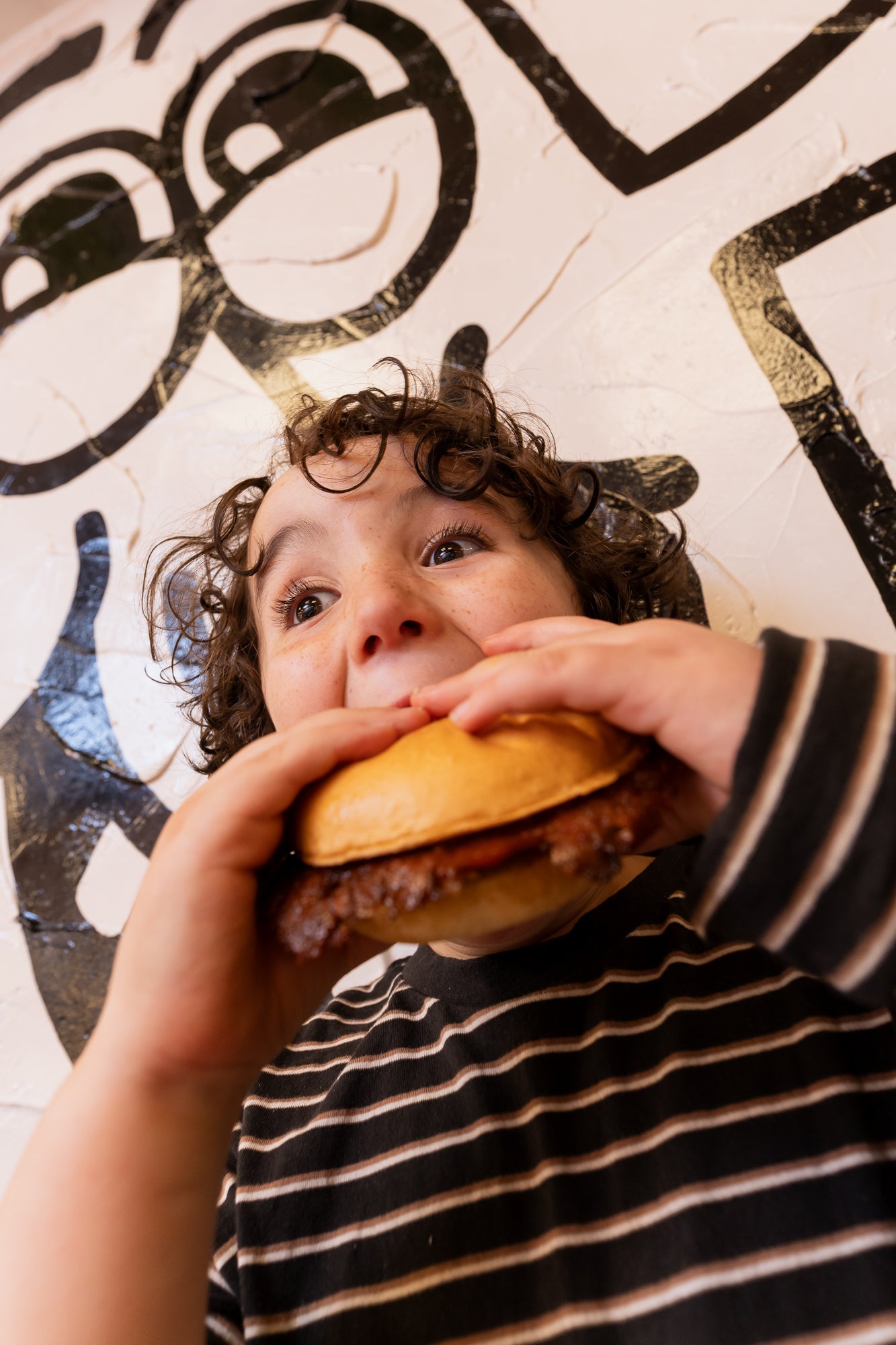 Member enjoying a Hoodburger cheeseburger